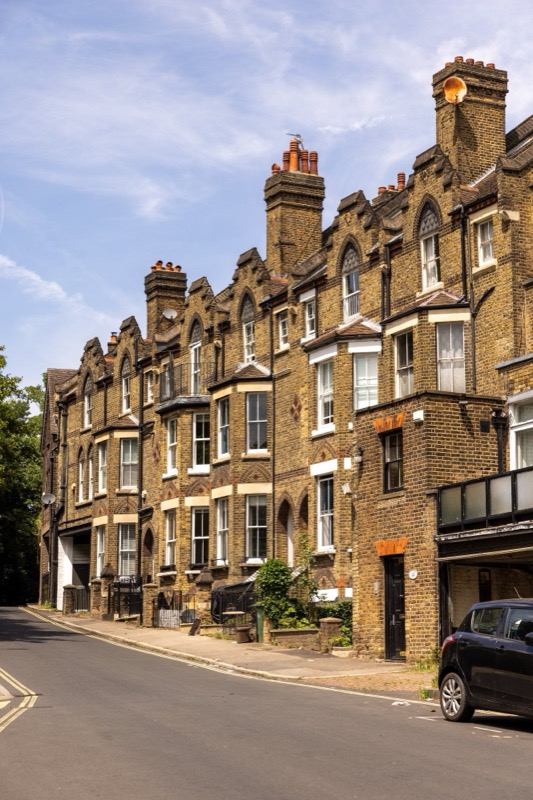 Luxury brick mansion with Bentley cars in driveway
