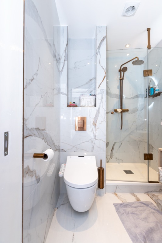 Luxury marble bathroom with brass rainfall shower