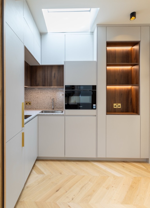 Modern kitchen with walnut accents and skylight