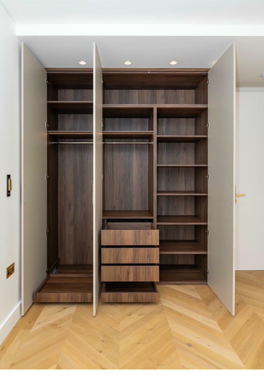 Bedroom with open wardrobe showing interior storage