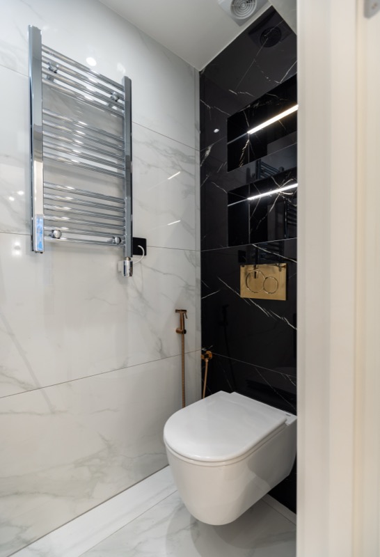 Contemporary bathroom with black and white marble and heated towel rail